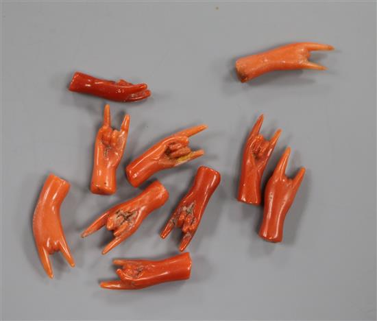 Ten miniature carved coral hands.
